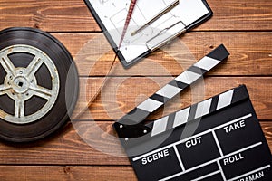 Work screenwriter on wooden background top view