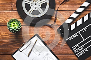 Work screenwriter on wooden background top view