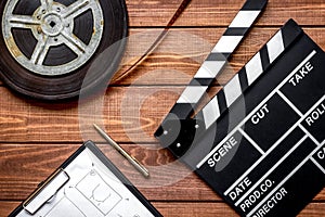 Work screenwriter on wooden background top view photo