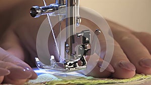 Work on the sewing machine, the seamstress sews the stitching