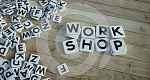 Work shop written in letter tiles wooden background
