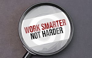 Work smarter not harder word on paper through magnifying lens