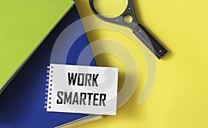 Work smarter reminders on a notepad, next to a magnifying glass and document folders