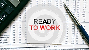 Work smarter text Ready to Work on white sheet with pen, calculator and tables