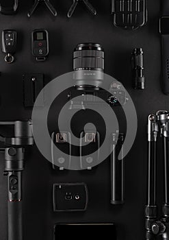 Work space videographer with laptop, digital camera, memory card, action camera, drone, remote controller, phone and camera