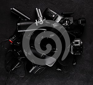 Work space videographer with laptop, digital camera, memory card, action camera, drone, remote controller, phone and camera