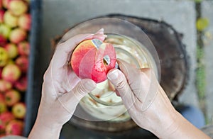 Making of apple vinegar - scene from above - hand peeling apples photo