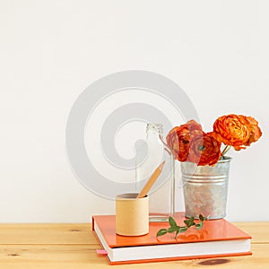 Work and study place. note book, pencil with floral decoration on wooden desk with white background