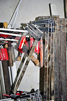 Work table of a carpenter with many tools olds hanging