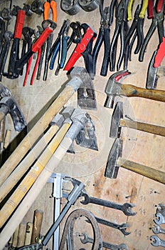 Work table of a carpenter with many tools olds hanging photo