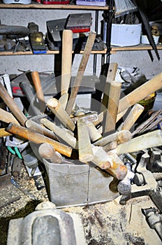 Work table of a carpenter with many tools olds hanging