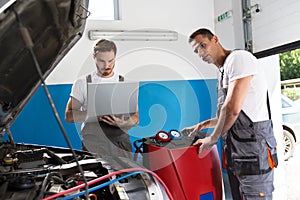 Work together in automobile shop photo
