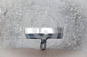 Work tool and equipment. workplace. working with spackling. Damaged wall repair. putty knife on gray grunge cement wall background