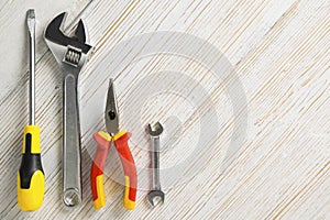 Work tools, different instrument on white wooden background