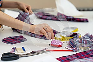 Work tools on the table in a tailors workshop - meter, scissors, needle