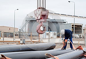 Work on unloading of pipes for construction.