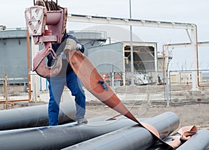 Work on unloading of pipes for construction.