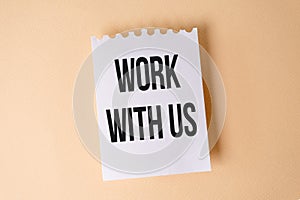 Work With Us Impression text on white sticky note on yellow background