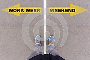 Work week vs weekend text arrows on asphalt ground, feet and shoes on floor