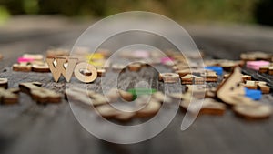 Work. Wooden letters on a dark blur background.