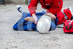 Work or workplace accident at construction site. First aid training. photo