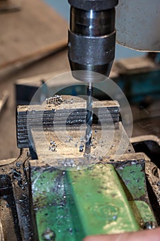 Work in the workshop and drill a hole with the drill