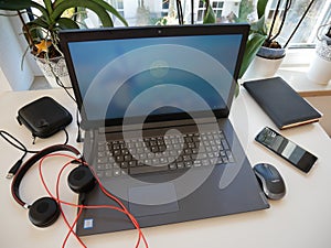 Worka from home - laptop, headset, mobile, notes and mouse