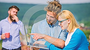 Workaholics concept. Colleagues with laptop work outdoor sunny day, nature background. Couple works despite of coffee