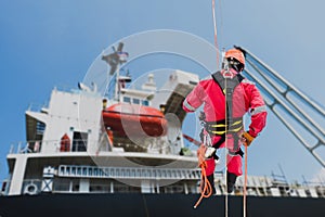 Worker abseiling and rope access sprinkle on high place