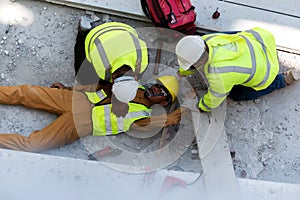 Worker accident at work in construction job near construct building. First aid, Start Compressions using both hands CPR, Rescue