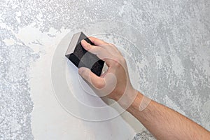 Worker aligns the sandpaper wall