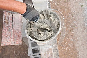 worker aligns with a spatula, lay brick cinderblocks photo