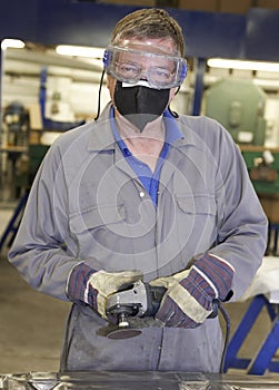 Worker with angle grinder