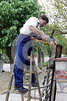Worker with angle grinder