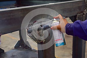 Worker apply developer.This is third step of Penetrant Testing PT