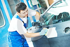 Worker applying car polish