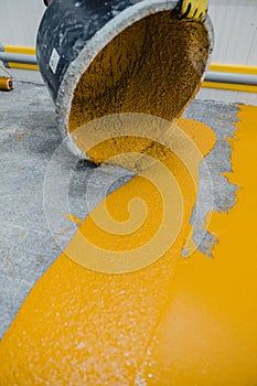 Worker applying epoxy and polyurethane flooring system