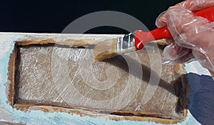 A worker is applying resin for repairing a hole
