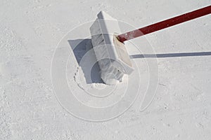 Worker applying white roof coating photo