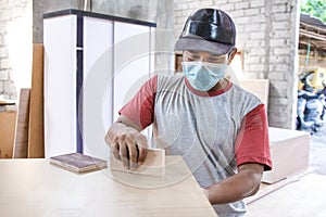 Worker applying wood board layer using wood superglue