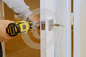 Worker assemble of lock in the wooden door