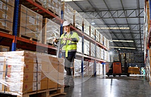 Worker in auto parts warehouse use a handcart to work to bring the box of auto parts into the storage