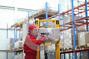 Worker with bar code reader working in warehouse