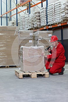 Worker with bar code reader working in warehouse