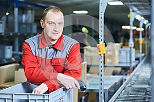 Worker with barcode scanner at warehouse