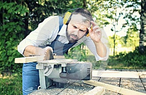 Worker beard man with circular saw