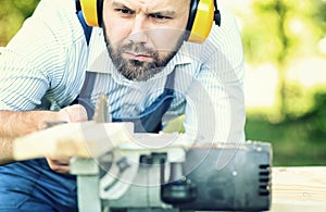 Worker beard man with circular saw