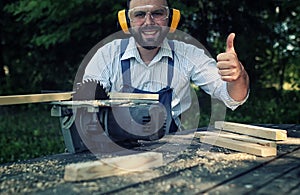 Worker beard man with circular saw