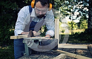 Worker beard man with circular saw