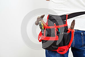 Worker belt with construction tools, closeup. Builder wearing belt with instruments for housework